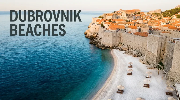 Aerial view of Banje Beach's white pebbles and sapphire water with the Old Town walls of Dubrovnik behind.