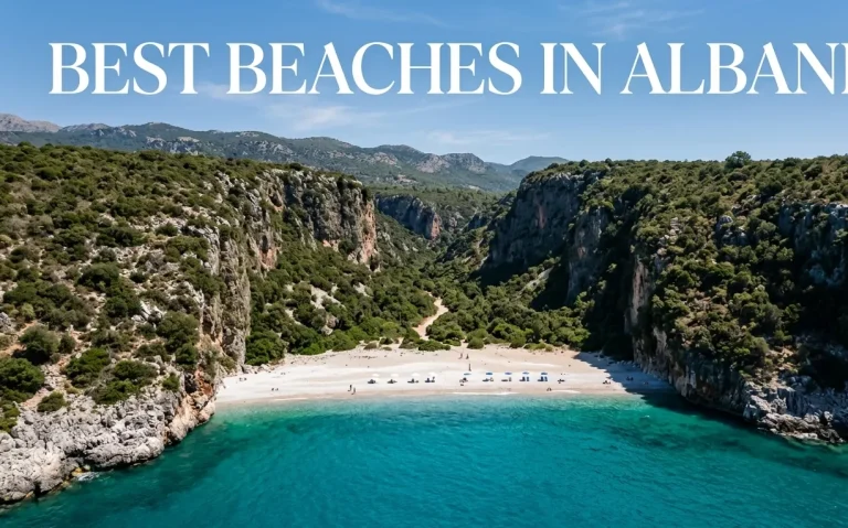 Aerial view of the stunning Gjipe Beach canyon and turquoise water on the Albanian Riviera, featuring the text Best Beaches in Albania.