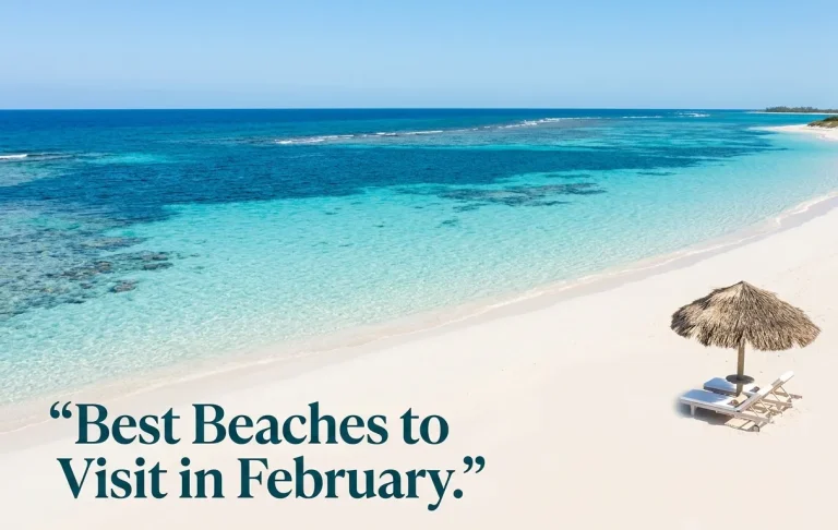 Aerial photo of Grace Bay Beach with empty white sand, crystal-clear calm turquoise water, and a single empty lounger under a palapa.
