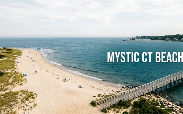 Aerial view of a calm New England beach with a wooden boardwalk, representing the best mystic ct beaches.